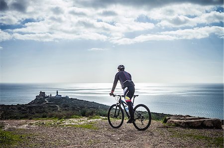 sardinia - Silhouetted view of male mountain biker on coastal path, Cagliari, Sardinia, Italy Stock Photo - Premium Royalty-Free, Code: 649-08085136