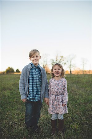 Portrait of boy holding sisters hand in field Stock Photo - Premium Royalty-Free, Code: 649-08085160