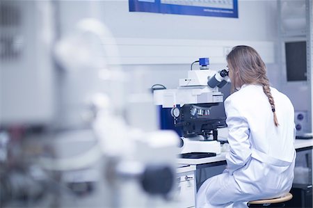 Female scientist looking through scanning electron microscope in lab Photographie de stock - Premium Libres de Droits, Code: 649-08085223