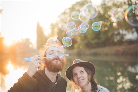 Young couple blowing bubbles Stock Photo - Premium Royalty-Free, Code: 649-08085384
