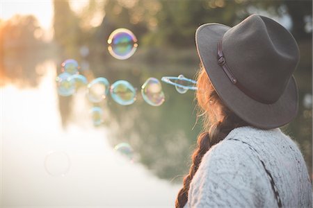 Young woman blowing bubbles Stock Photo - Premium Royalty-Free, Code: 649-08085386