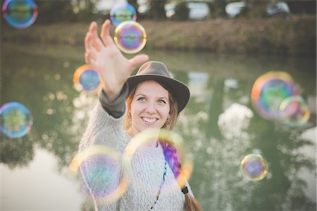 simsearch:649-07065228,k - Young woman playing with bubbles Stock Photo - Premium Royalty-Free, Code: 649-08085382