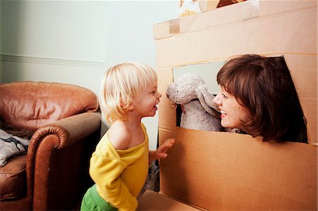play - Mother and son playing with cardboard box window in living room Stock Photo - Premium Royalty-Free, Code: 649-08085432