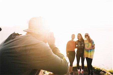 Young man photographing female friends at Lake Atitlan on digital camera, Guatemala Stock Photo - Premium Royalty-Free, Code: 649-08085487
