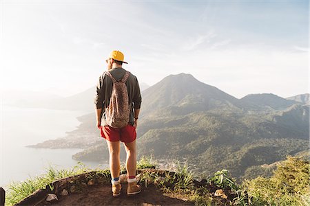 Rear view of young man looking out over Lake Atitlan, Guatemala Stock Photo - Premium Royalty-Free, Code: 649-08085492
