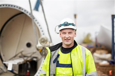 environmental issues and global warming - Portrait of engineer at wind farm Stock Photo - Premium Royalty-Free, Code: 649-08085538