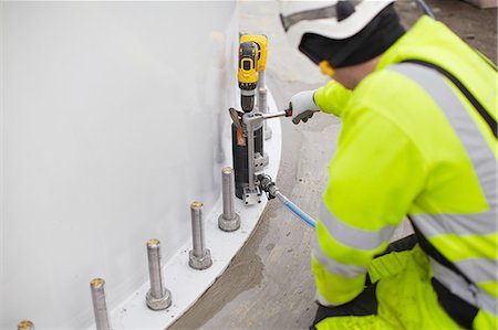 Engineer working on wind turbine, rear view Stock Photo - Premium Royalty-Free, Code: 649-08085555