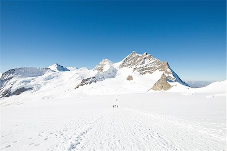 footprint winter landscape mountain - View of tracks in snow covered mountain landscape, Jungfrauchjoch, Grindelwald, Switzerland Stock Photo - Premium Royalty-Free, Code: 649-08085719