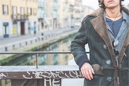 pictures of musicians with headphones - Man standing by canal, Milan, Italy Stock Photo - Premium Royalty-Free, Code: 649-08085899