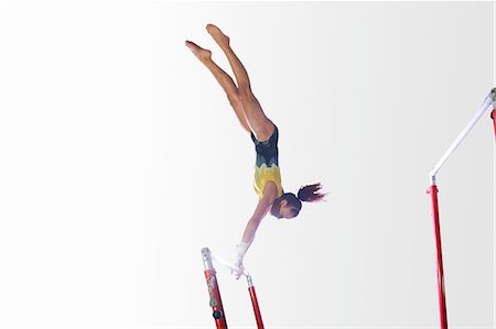 simsearch:640-06050725,k - Young gymnast performing on uneven bars Photographie de stock - Premium Libres de Droits, Code: 649-08085963