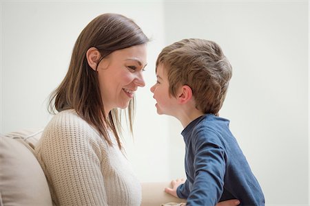 Mother and son smiling at each other, face to face Stock Photo - Premium Royalty-Free, Code: 649-08085999