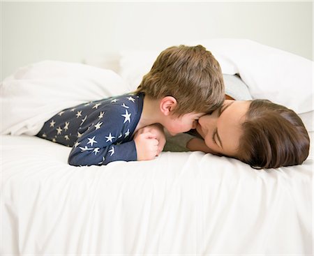 simsearch:649-08237787,k - Mother and son playing together in bed Stock Photo - Premium Royalty-Free, Code: 649-08086001