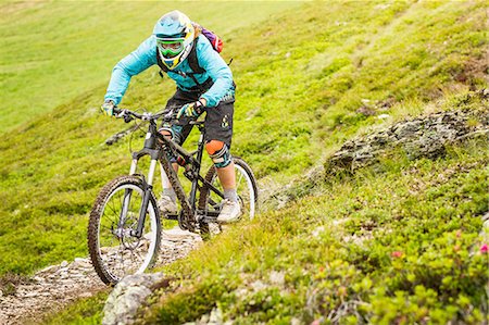 simsearch:649-06829975,k - Young female mountain biker cycling on hillside track Stock Photo - Premium Royalty-Free, Code: 649-08086068