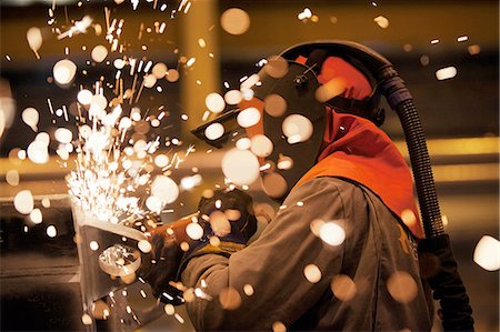 engineering tools images - Sparks and worker using grinder Stock Photo - Premium Royalty-Free, Code: 649-08086116