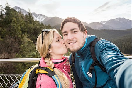 Young hiking couple taking selfie in mountains, Reutte, Tyrol, Austria Stock Photo - Premium Royalty-Free, Code: 649-08086380