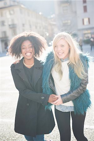 simsearch:649-08086803,k - Portrait of two female friends laughing in town square Fotografie stock - Premium Royalty-Free, Codice: 649-08086403