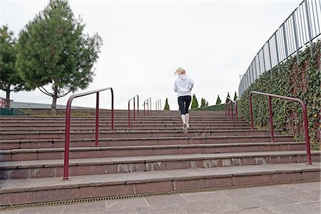 simsearch:649-07438053,k - Young woman running up steps, rear view Stock Photo - Premium Royalty-Free, Code: 649-08086668