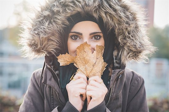 Close up of beautiful young woman in park holding up autumn leaf in front of face Photographie de stock - Premium Libres de Droits, Le code de l’image : 649-08086844