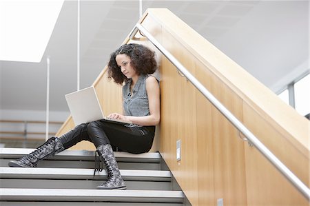 simsearch:649-07736471,k - Businesswoman using laptop on office stairway Photographie de stock - Premium Libres de Droits, Code: 649-08117788