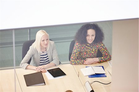 High angle view of businesswomen having meeting at conference table Stock Photo - Premium Royalty-Free, Code: 649-08117807