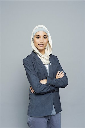 portrait people grey background - Studio portrait of young businesswoman wearing hijab Stock Photo - Premium Royalty-Free, Code: 649-08117876