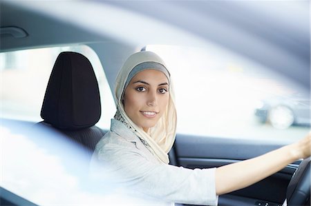 Portrait of young businesswoman wearing hijab driving car Stock Photo - Premium Royalty-Free, Code: 649-08117907