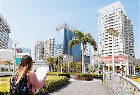 Rear view of young female tourist reading map, Macau, Hong Kong, China Photographie de stock - Premium Libres de Droits, Code: 649-08117925