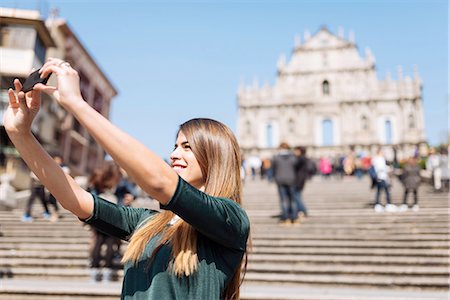 Young female tourist taking smartphone selfie in front of St Pauls Cathedral ruins, Macau, Hong Kong, China Photographie de stock - Premium Libres de Droits, Code: 649-08117927