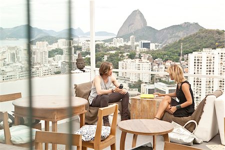 Young couple chatting on rooftop terrace, Rio De Janeiro, Brazil Stock Photo - Premium Royalty-Free, Code: 649-08118067