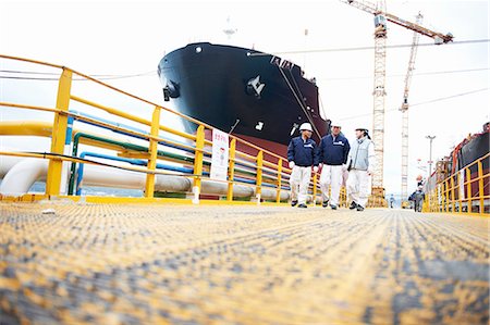 freighter - Three workers at shipping port, low angle view, GoSeong-gun, South Korea Stock Photo - Premium Royalty-Free, Code: 649-08118280