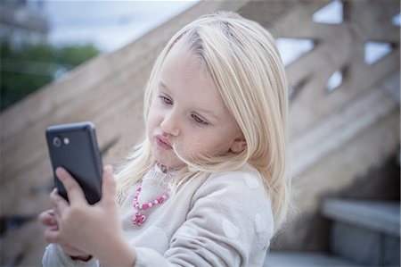 simsearch:649-08118449,k - Confused young girl on stairway using smartphone, Cagliari, Sardinia, Italy Stock Photo - Premium Royalty-Free, Code: 649-08118443