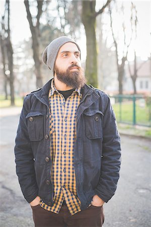 simsearch:649-08125285,k - Portrait of mid adult man, standing in park, hands in pockets Photographie de stock - Premium Libres de Droits, Code: 649-08118579