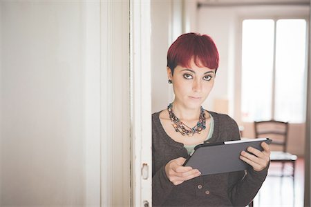 Young woman at home using digital tablet Stock Photo - Premium Royalty-Free, Code: 649-08118604