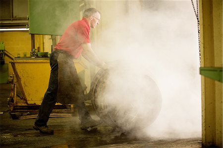 Male cooper rolling whisky cask in cooperage Stock Photo - Premium Royalty-Free, Code: 649-08118617