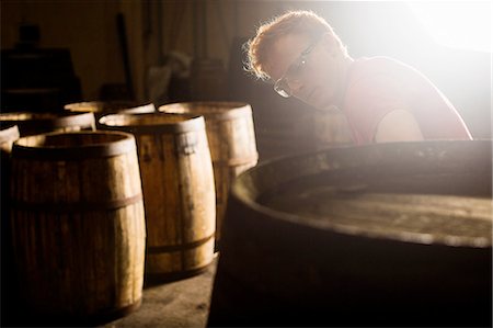 european culture - Young man working in cooperage with whisky casks Stock Photo - Premium Royalty-Free, Code: 649-08118622
