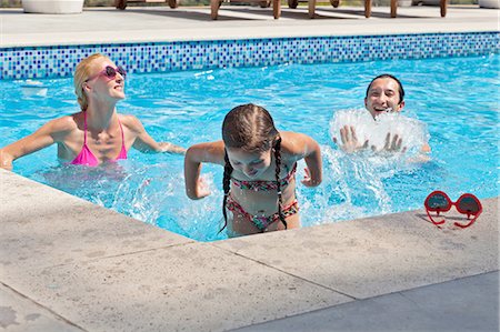 family daughter splashing images - Young family fooling around in outdoor pool Stock Photo - Premium Royalty-Free, Code: 649-08119048