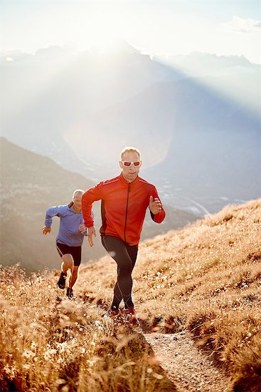 Trail runners on dirt track, Valais, Switzerland Stock Photo - Premium Royalty-Free, Image code: 649-08119096