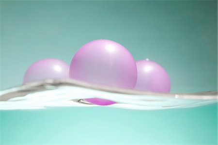 Pink balloons floating on water surface Stock Photo - Premium Royalty-Free, Code: 649-08119134