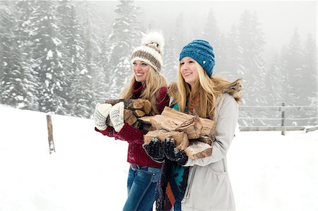 simsearch:649-08124900,k - Two young female friends carrying logs in snowy mist Stock Photo - Premium Royalty-Free, Code: 649-08124909