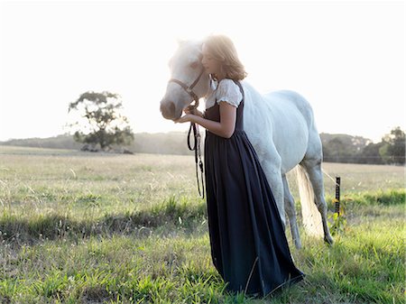 simsearch:649-08900813,k - Portrait of teenage girl with grey horse in sunlit field Stock Photo - Premium Royalty-Free, Code: 649-08124914