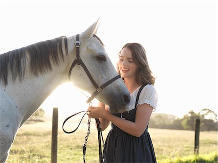 simsearch:649-08900813,k - Portrait of teenage girl and her grey horse in sunlit field Stock Photo - Premium Royalty-Free, Code: 649-08124916