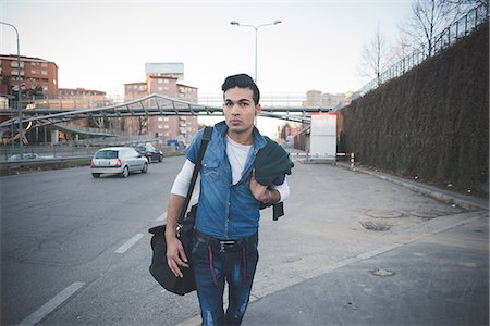 Young man in the street, Milan, Italy Stock Photo - Premium Royalty-Free, Code: 649-08125127
