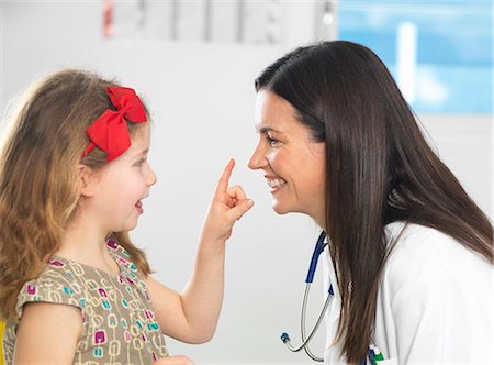 Doctor bonding with young girl during consultation Stock Photo - Premium Royalty-Free, Code: 649-08125155