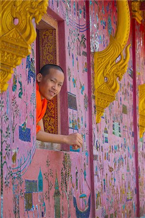 Buddhist monk looking out of Wat Xieng Thong window, Luang Prabang, Laos Stock Photo - Premium Royalty-Free, Code: 649-08125423