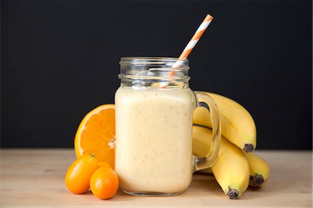 Still life of fresh banana, orange and kumquat smoothie Stock Photo - Premium Royalty-Free, Code: 649-08125430