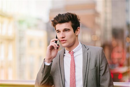 simsearch:649-08180080,k - Young city businessman talking on smartphone  outside office Stock Photo - Premium Royalty-Free, Code: 649-08125479