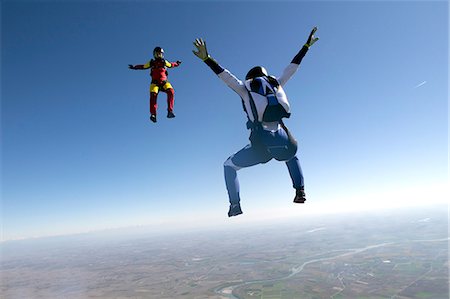 skydiving in a business suit - Freeflying skydivers in blue sky Stock Photo - Premium Royalty-Free, Code: 649-08125854