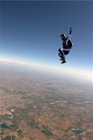 skydiver - Freeflying skydiver in blue sky Stock Photo - Premium Royalty-Free, Code: 649-08125857