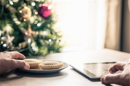 Person using digital tablet with mince pies Stock Photo - Premium Royalty-Free, Code: 649-08125893