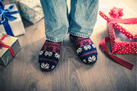 photo person slipper - Man wearing slippers with christmas gifts on floor Stock Photo - Premium Royalty-Free, Code: 649-08125910